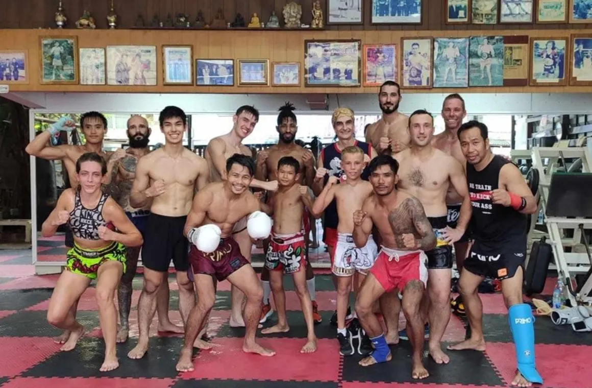 Group of Muay Thai lovers posing together after class at Eminent Air Boxing Gym, celebrating their training experience