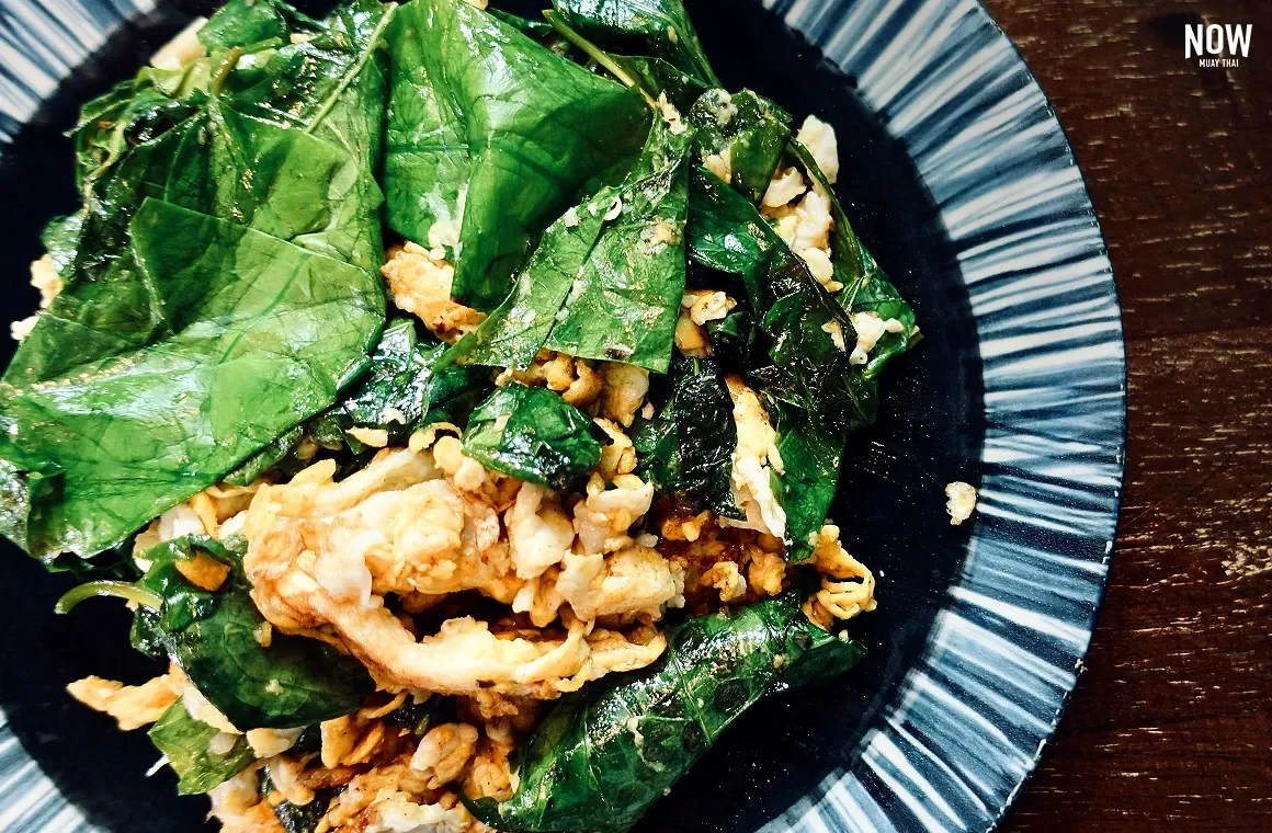 Bai Leang Pad Khai, a Southern Thai dish made from stir-fried malindjo leaves with egg, offering a savory, nutritious balance perfect for health-conscious diners.