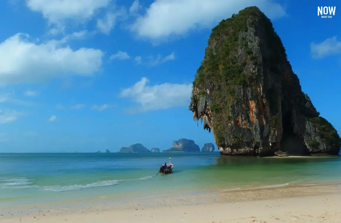 Scenic view of Koh Poda beach with cloudy sky and distant view of Koh Ma Tang Ming in Krabi, Thailand.