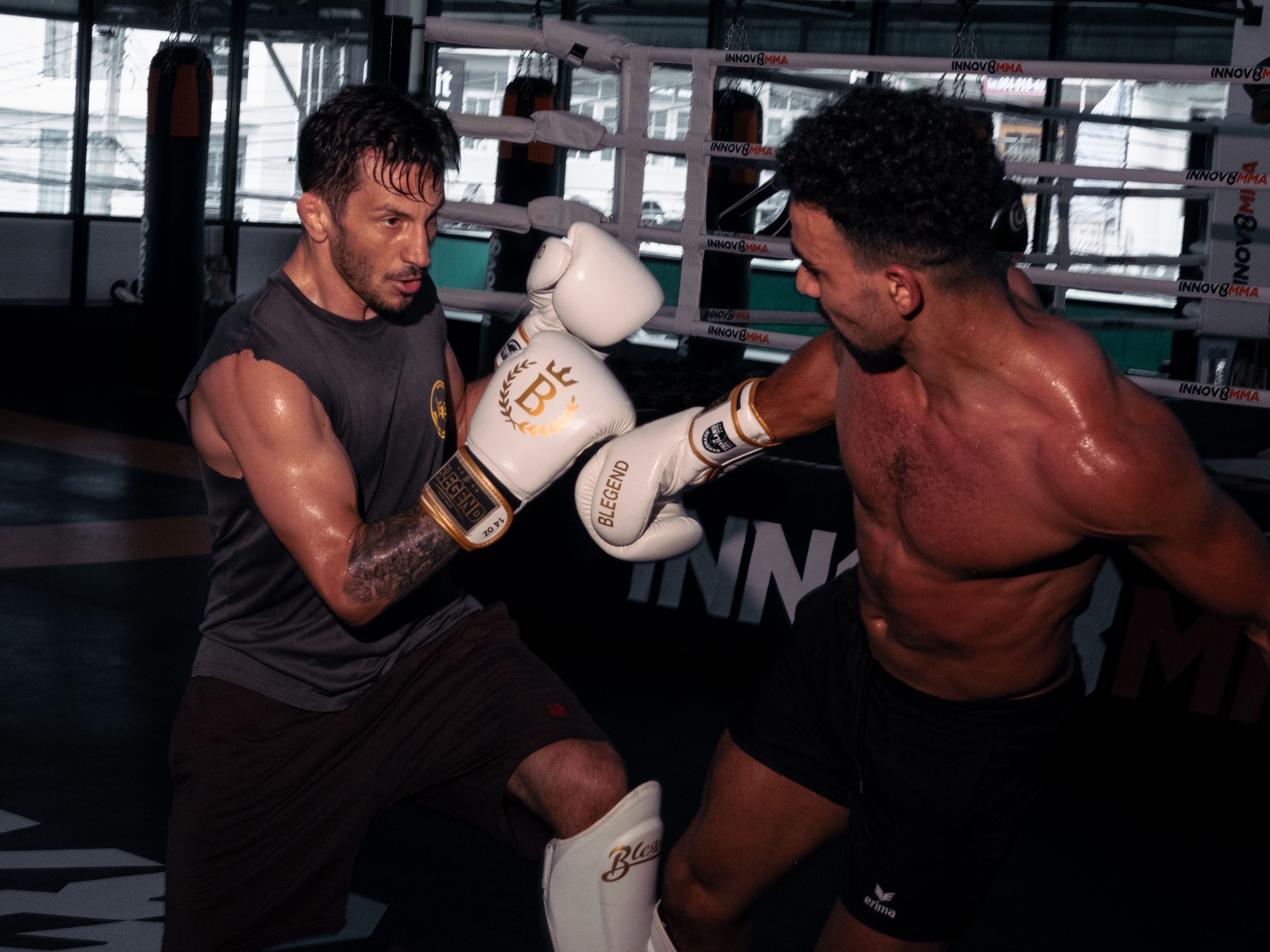 Students training Muay Thai with pads at Innov8 MMA Bangkok