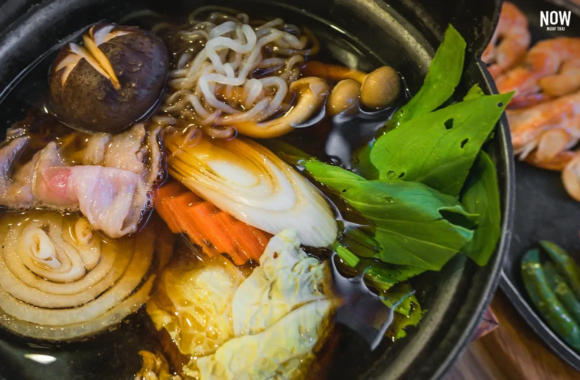 Japanese-style pork sukiyaki with vegetables in a light broth, a balanced dish high in protein, fiber, and minerals that supports muscle growth, metabolism, and overall digestive health
