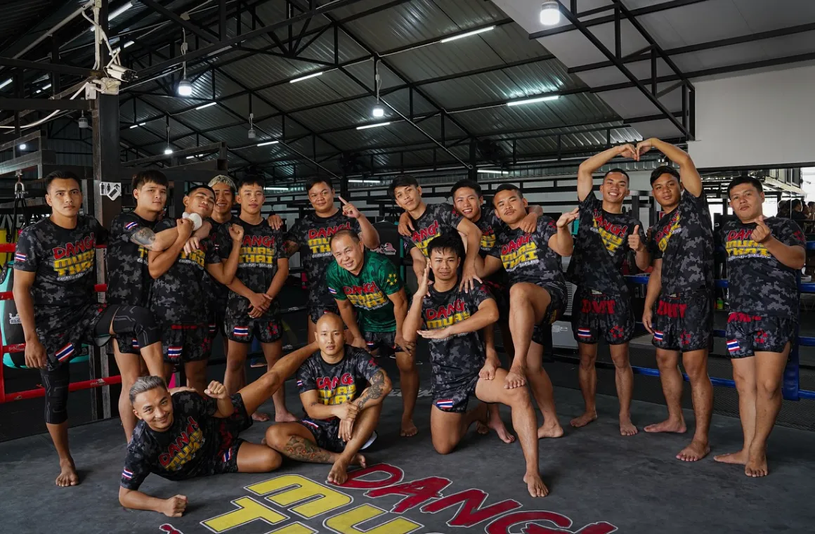 Trainers at Dang Muay Thai Gym in Chiang Mai downtown smiling and ready to welcome students for an authentic Muay Thai training experience