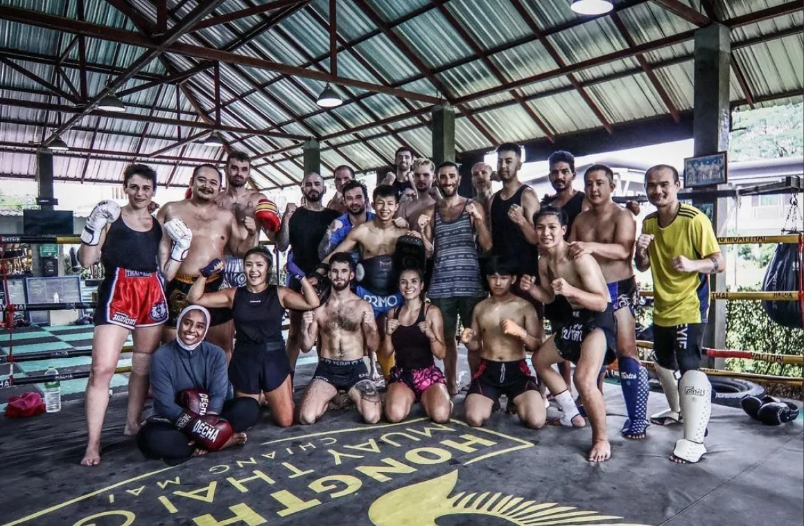Kru Joe and his Muay Thai students at Hongthong Muay Thai Gym in Chiang Mai posing together after a rewarding training session, showing teamwork and authentic Thai boxing spirit
