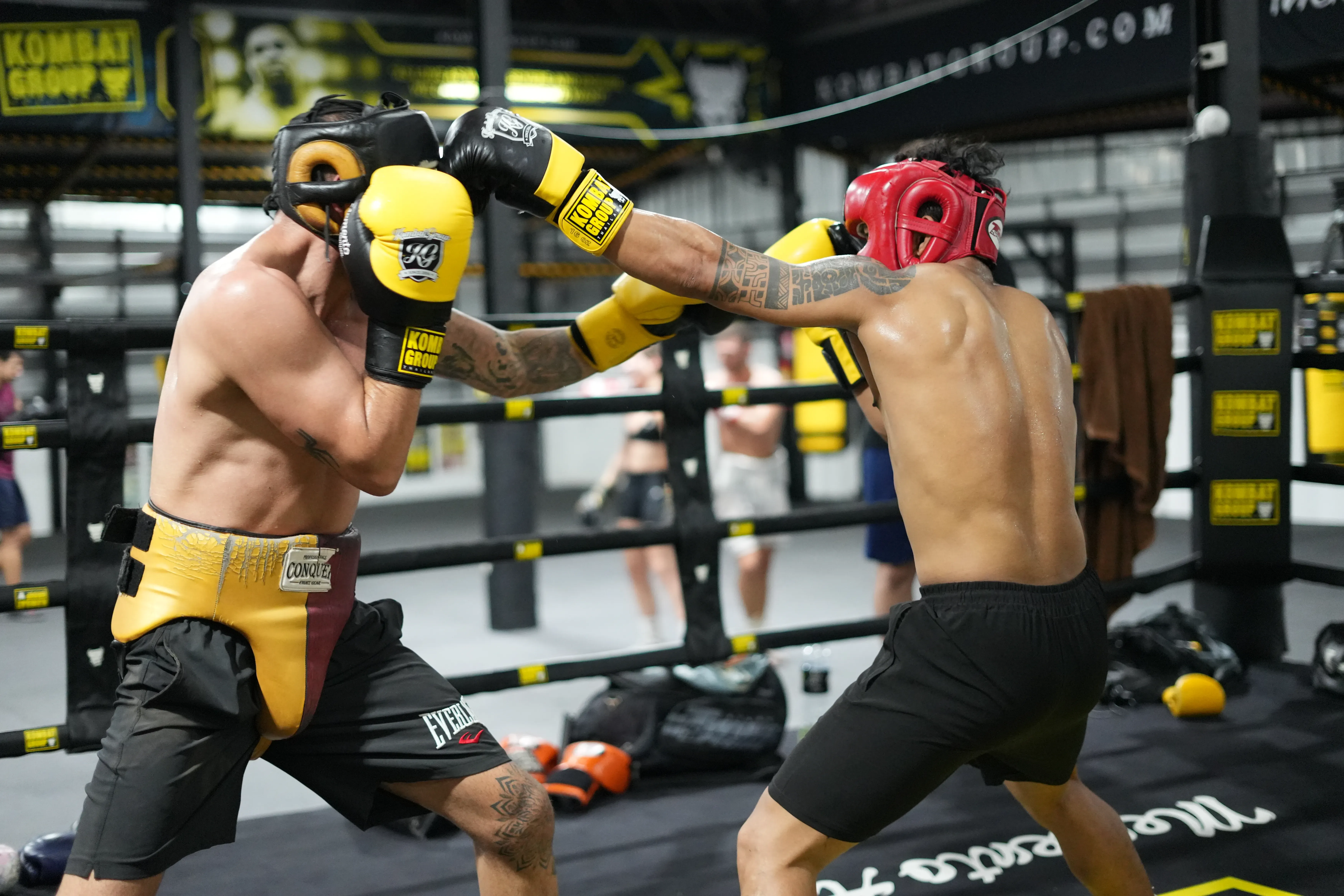 Muay Thai sparring session with protective gear at Kombat Group Thailand.